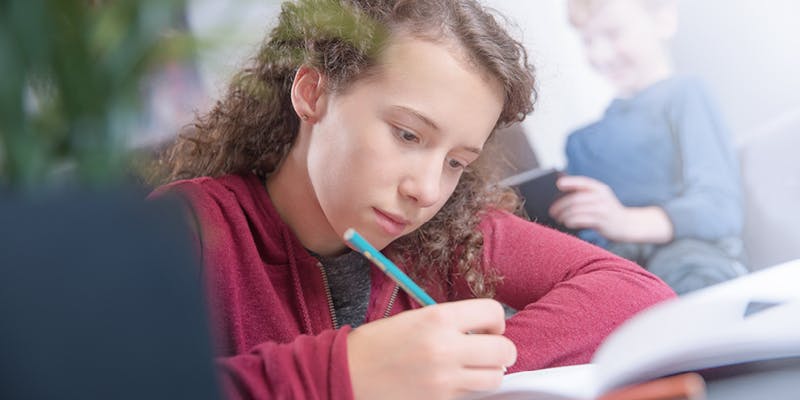 A kid using their at-home homework space.