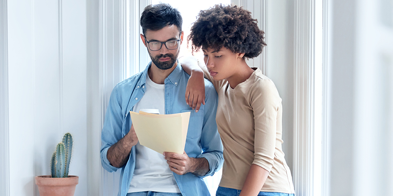 Two people looking at a bill and considering unpaid tax options