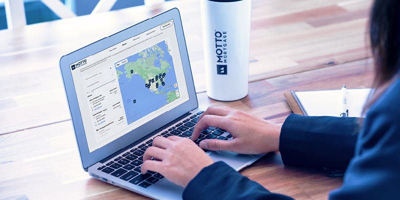 Person researching best franchise locations on a laptop. 
