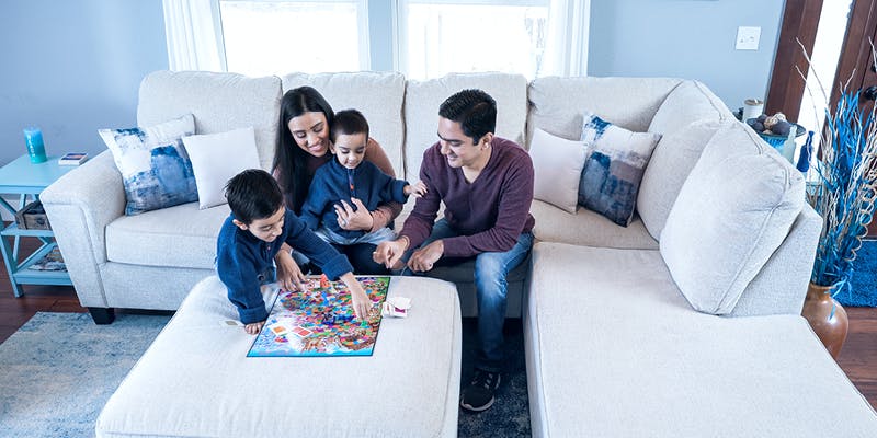 A family in a nature-inspired room. On trend home decor for 2024. 