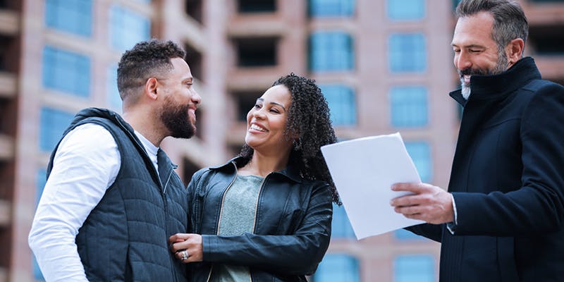 A mortgage broker helping a couple with a home loan