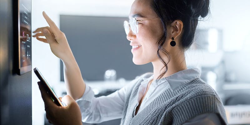 Woman working on a tablet and cell phone