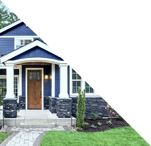 A modern navy blue house with white trim, a wooden front door, stone columns, and a small garden is partially obscured by a large white triangular overlay in the upper right corner.