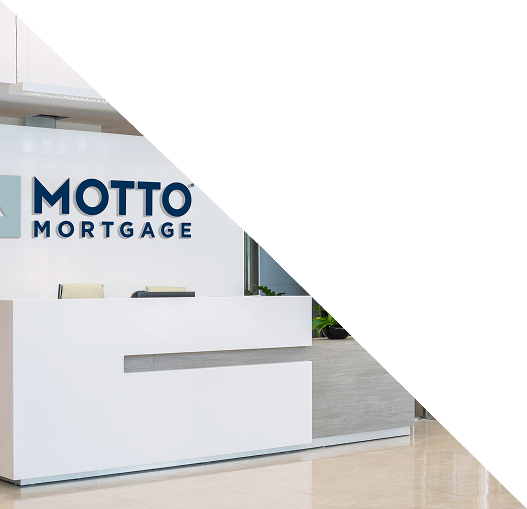 A modern reception desk in an office lobby with MOTTO MORTGAGE signage on the wall behind it. The image is partially covered by a large white triangular overlay.